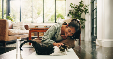 Yoga, woman and pet cat in house for care, love and bonding with companion on fitness break. Lounge, yogi and stroke kitty on mat for support with smile, connection and post exercise on floor © OnPoint/peopleimages.com