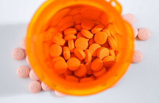 Close up of Round Pink Statin Pills with Number 5 for Dosage on Them