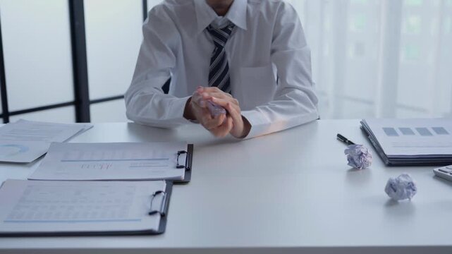 Businessman crumpled paper and throw on desk