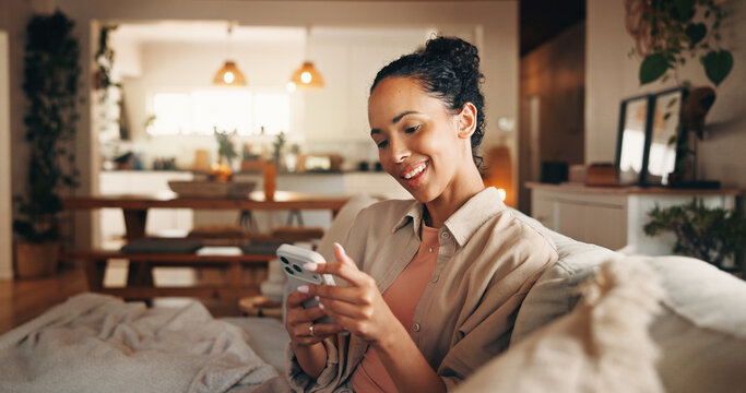 Woman, smile and reading in home with phone, text message notification and website for digital news. Female person, typing and browsing on sofa with tech, social media or mobile app for blog article.
