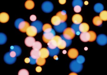 Warm and Cool Color Bokeh Mix: Orange, Peach and Blue Light Circles Blurred on Black Night Background for Festive Abstract Mood

