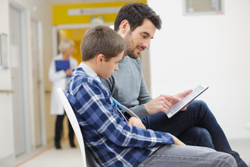 a boy and dad at the waiting room
