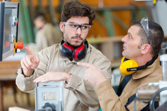 worker operating a machine in a factory