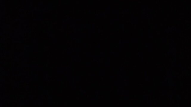 A minimalist digital background featuring a uniform grid of glowing red circular lights.