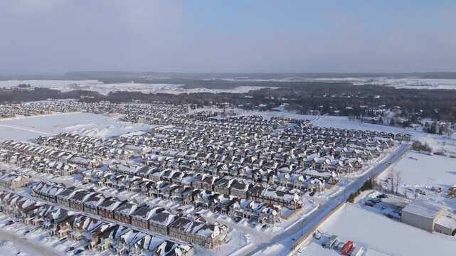 Suburban housing development expands in snowy Erin Ontario near Toronto, Aerial