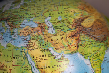 World map with focus on Iran.  The United States and Iran are on the brink of war. Political tension or crisis. Part of the world map. Middle Eastern countries are in focus. Selective focus. No people © Burak