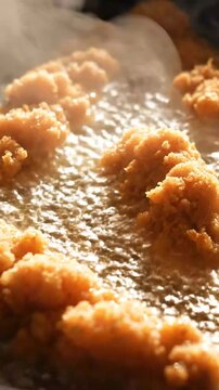 Crispy chicken nuggets frying in hot oil, close-up on bubbly cooking process