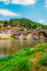 Obraz premium Old Stone Bridge (Stara Cuprija) over the Neretva River in Konjic, a masterpiece of Ottoman architecture, Bosnia and Herzegovina.