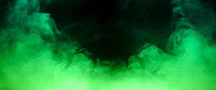 Colorful smoke with green flare isolated on a black background. abstract neon gradient cloud with splash. thick swirling dust and powder creating a psychedelic light design. smog effect