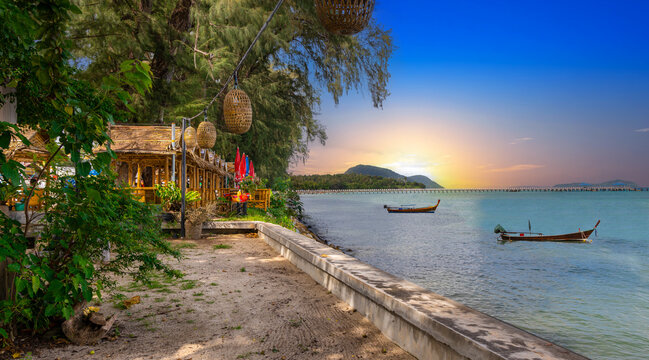Colourful Skies Sunset over Rawai Beach in Phuket island Thailand. Lovely turquoise blue waters, lush green mountains colourful skies and beautiful views of Pa Tong Patong