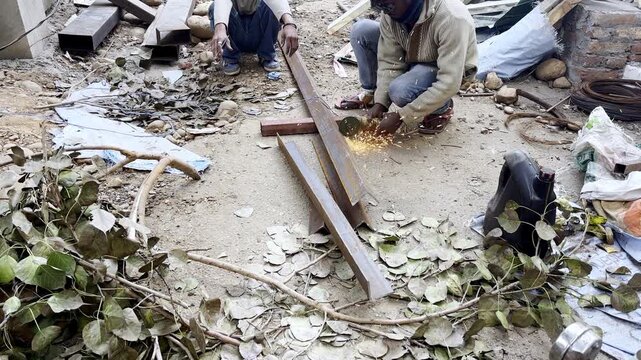 A man cutting iron pipe 