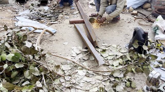 A man cutting iron pipe 