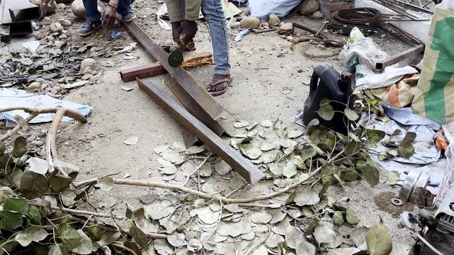 A man cutting iron pipe 