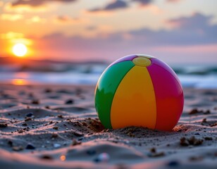 Obraz premium Colorful Beach Ball Sunset Wet Sand