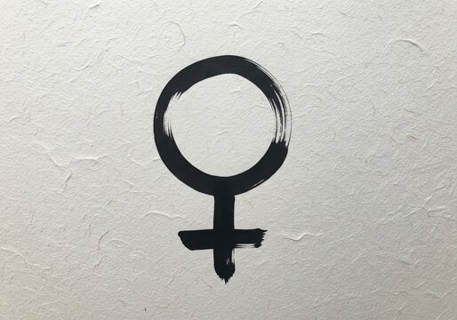 A black female symbol painted on a textured white wall 