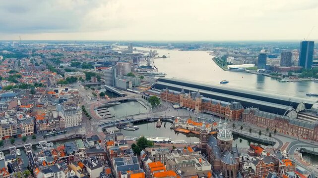 Amsterdam, Netherlands. Amsterdam Central Station. Amsterdam Centraal - The largest train station in the city, built in 1889. Bay IJ (Amsterdam). Drone footage, Point of interest