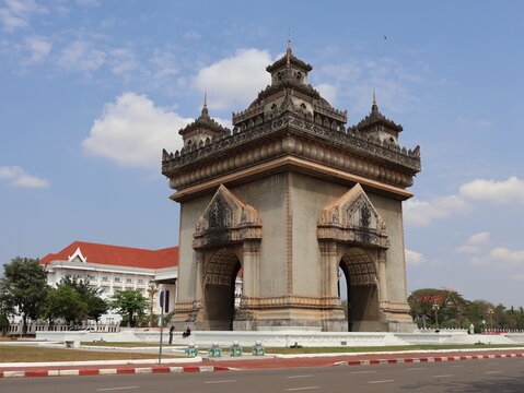 VIENTIANE, LAOS - FEBRUARY 25, 2026: The iconic Patuxay Victory Gate monument under a blue sky with tourists visiting.
