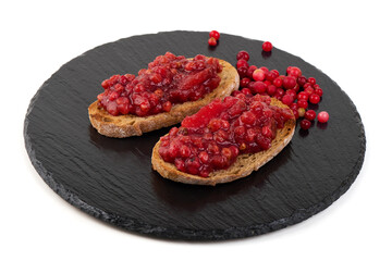 Obraz premium Lingonberry Toast on Black Slate, isolated on white background