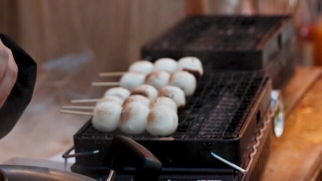 Vendor Grilling Dango Skewers at Japanese Street Food Stall