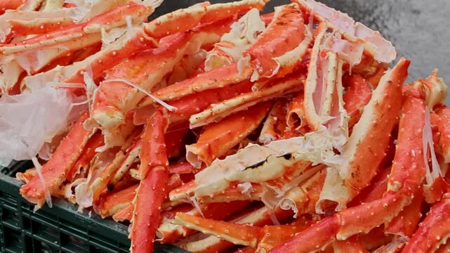 Wholesale supplier loads crab legs into boxes for shipment