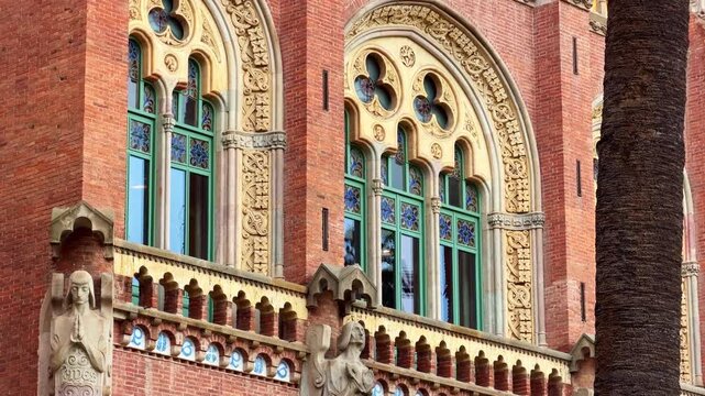 Art nouveau sculptures and windows on the facade of Hospital de Sant Pau in Barcelona, Spain. Tilt-up
