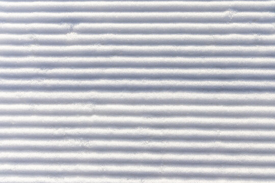Snow groomed by a snowcat on a ski slope. Poland. Snow background.