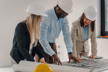 Engineers team discussing building plans and blueprints