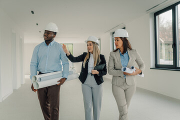 Construction team walking through project site discussing progress