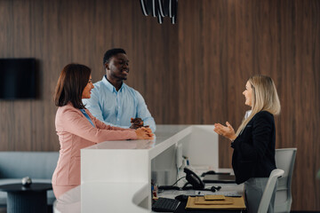 Business people discussing with a smiling receptionist