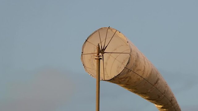 Close Up of a White Wind Sock Swaying Against Blue Sky
