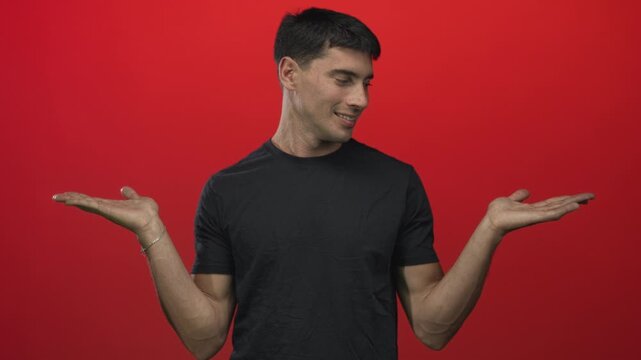 Man spreads open hands in studio under bright lighting to illustrate choice and contemplation; uncertainty.
