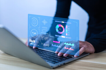  A person works on a laptop with a dashboard for data analysis and database-connected metrics for operations in finance, sales, marketing, digital transformation, and business intelligence. 