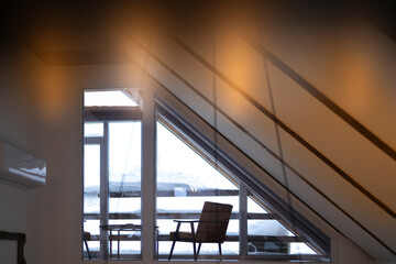 Cozy Mountain Lodge Interior with Large Wooden Beams and Snowy Window View