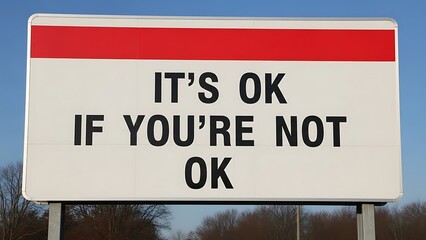 Fototapeta premium Large white sign with red displaying black text saying its ok if youre not ok against blue sky billboard