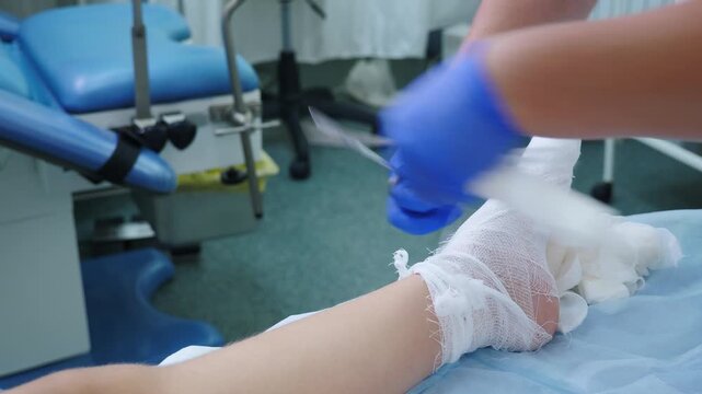 Traumatologist doctor bandages patient foot in hospital . Broken foot, toe fracture. Elastic bandage. injury concept. Healthcare and medicine. clean and sterile environment. 4 k video