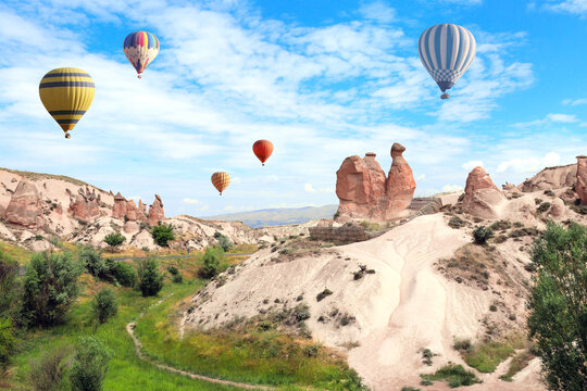 Balloon flight, famous tourist attraction of Cappadocia. Air balloons and Camel rock at Devrent valley (Imaginary valley), Cappadocia, Turkey. Topic of vacation, travel, trip abroad, cruises and tours