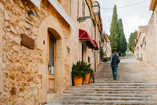 Man walking up El Calvari steps in Pollen&ccedil;a, Mallorca, Spain