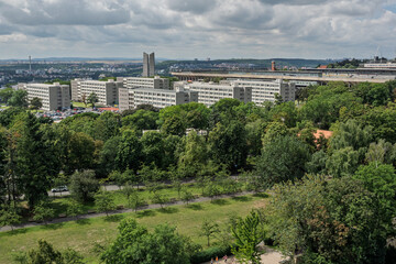 View Of Large Communist Era Apartment Buildings And Monolithic Spire Behind Green Park, Prague, Czech Republic