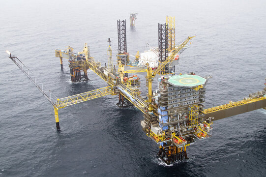 Esbjerg, Denmark - 13 February 2026: Aerial view of a vast offshore oil platform gleaming against the muted tones of the North Sea, an industrial titan amidst the waves.