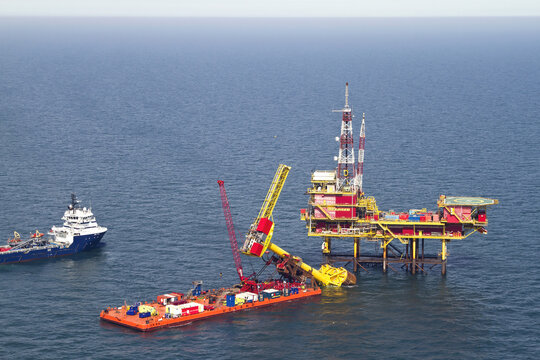Netherlands, Netherlands - 13 February 2026: Aerial view of a vibrant offshore platform standing tall amidst the vast expanse of the deep blue sea, a testament to human engineering.