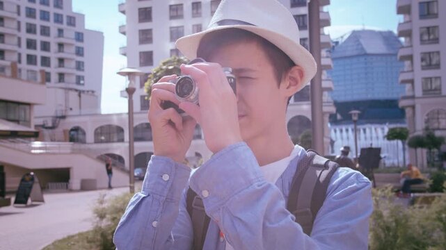 Exploring the City: Young Boy Using a Camera to Capture Beautiful Urban Shots