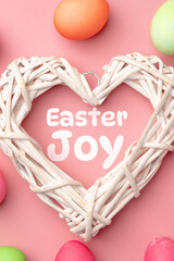 Fototapeta premium Easter joy is celebrated with colorful eggs and a heart-shaped decoration on a pink background