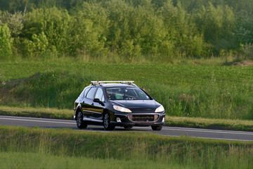 Luxury wagon traveling through green landscape