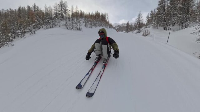 Skier Sliding Down Snowy Slope While Sitting On Skis In Serre Chevalier, French Alps, Fun Winter Sports Moment, Aerial Action View