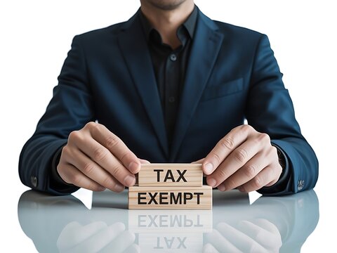 Man in a suit holds wooden blocks spelling 'TAX EXEMPT', signifying financial strategy and tax relief. Next Generation Interior Concept &ndash; Premium Visual Design
