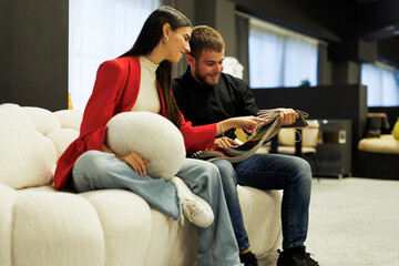 Couple choosing fabric swatches for new sofa