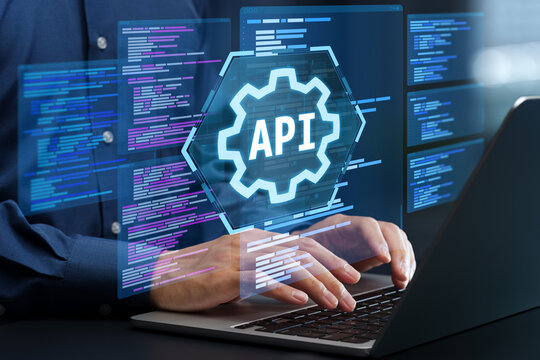 API development. Engineer using laptop computer to design API. Programmer writing code based on the specifications.