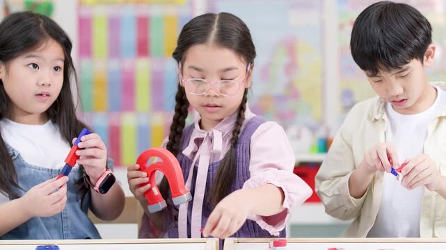 Children Conduct Magnet Science Experiment in Bright Classroom