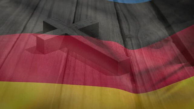 US flag sliding in, causing German tricolor rippling over wood and cross, forming overlay