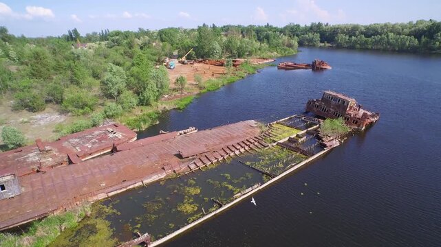 Aerial view of rusted ships in Chernobyl's radioactive ship graveyard, a haunting reminder of the nuclear disaster.